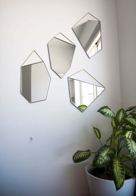 The latest designs of mirrors with geometric shapes decorate the walls of the modern home